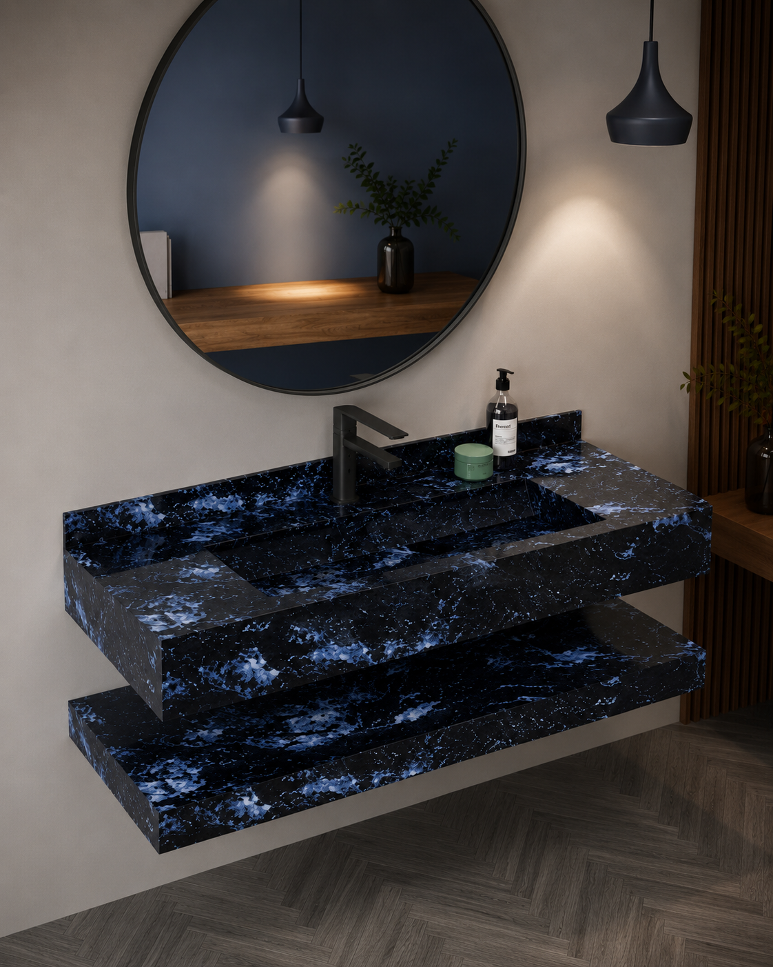 Bathroom vanity with black marble countertop, round mirror, and decorative items.