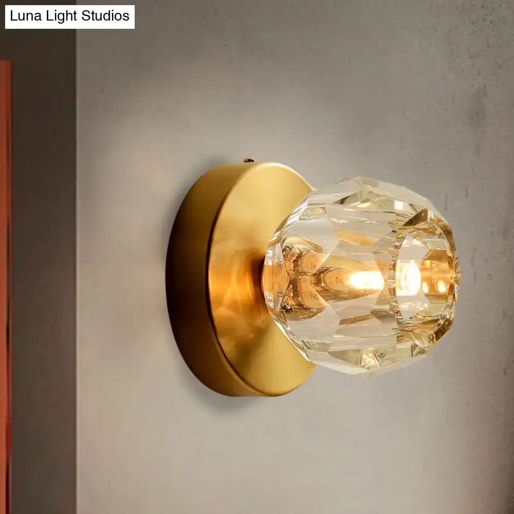 Contemporary golden wall mount lamp with faceted glass shade living room