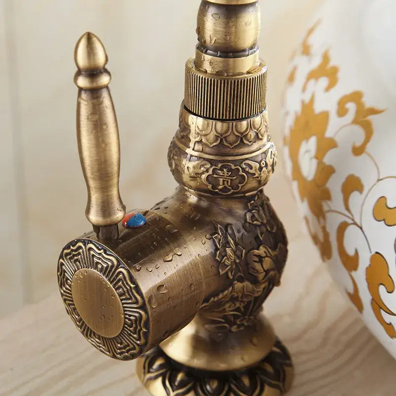Antique bronze basin faucet with ornate detailing for bathroom