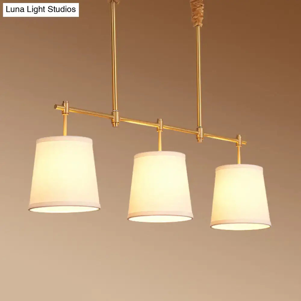 Modern gold island chandelier with fabric empire shade dining room