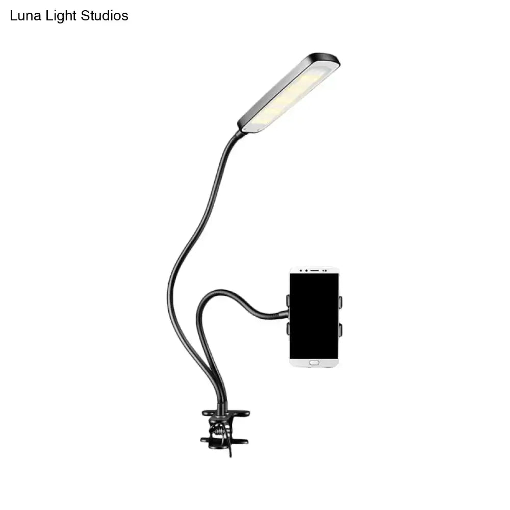 Minimalist black flexible arm desk lamp with phone holder bedroom