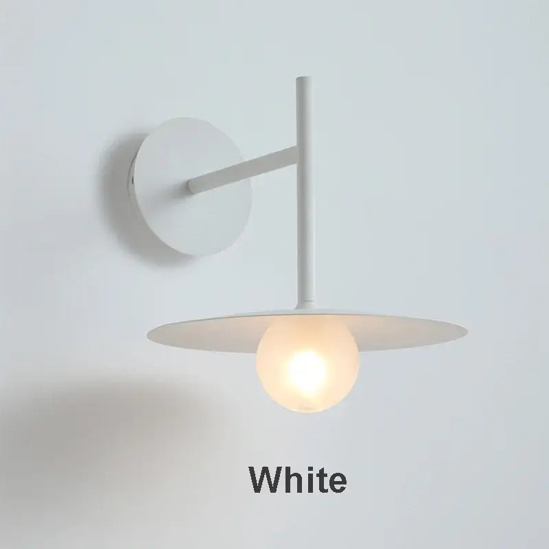 Minimalist black flying saucer wall lamp for bedroom decor