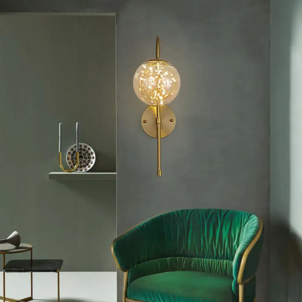 Minimalist gold gooseneck wall light with fairy light globe bedroom