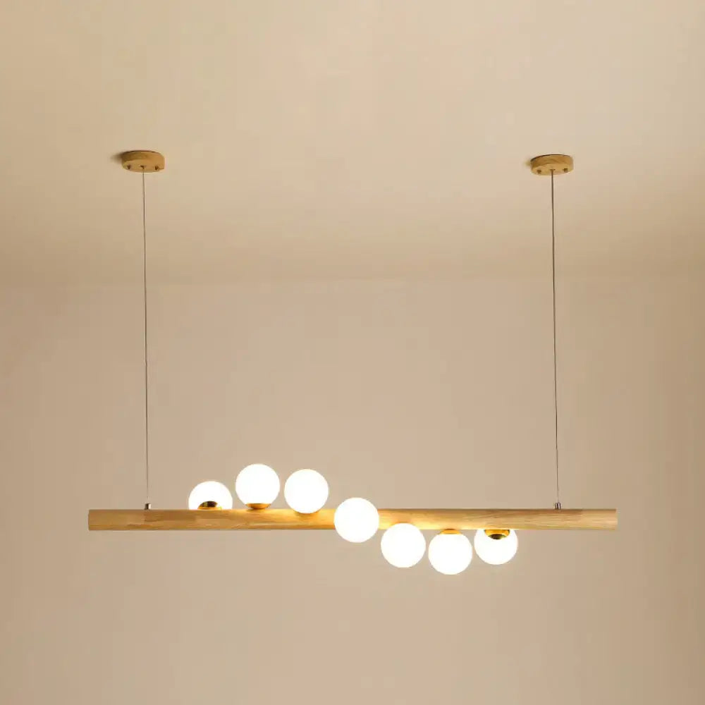 Minimalist wood and glass linear island pendant for kitchen lighting