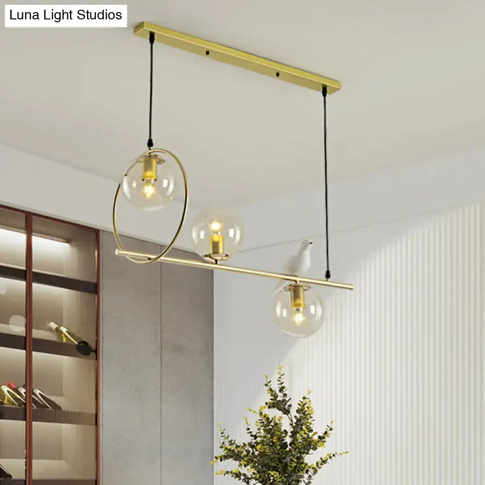 Modern brass global island lamp with white bird dining room light