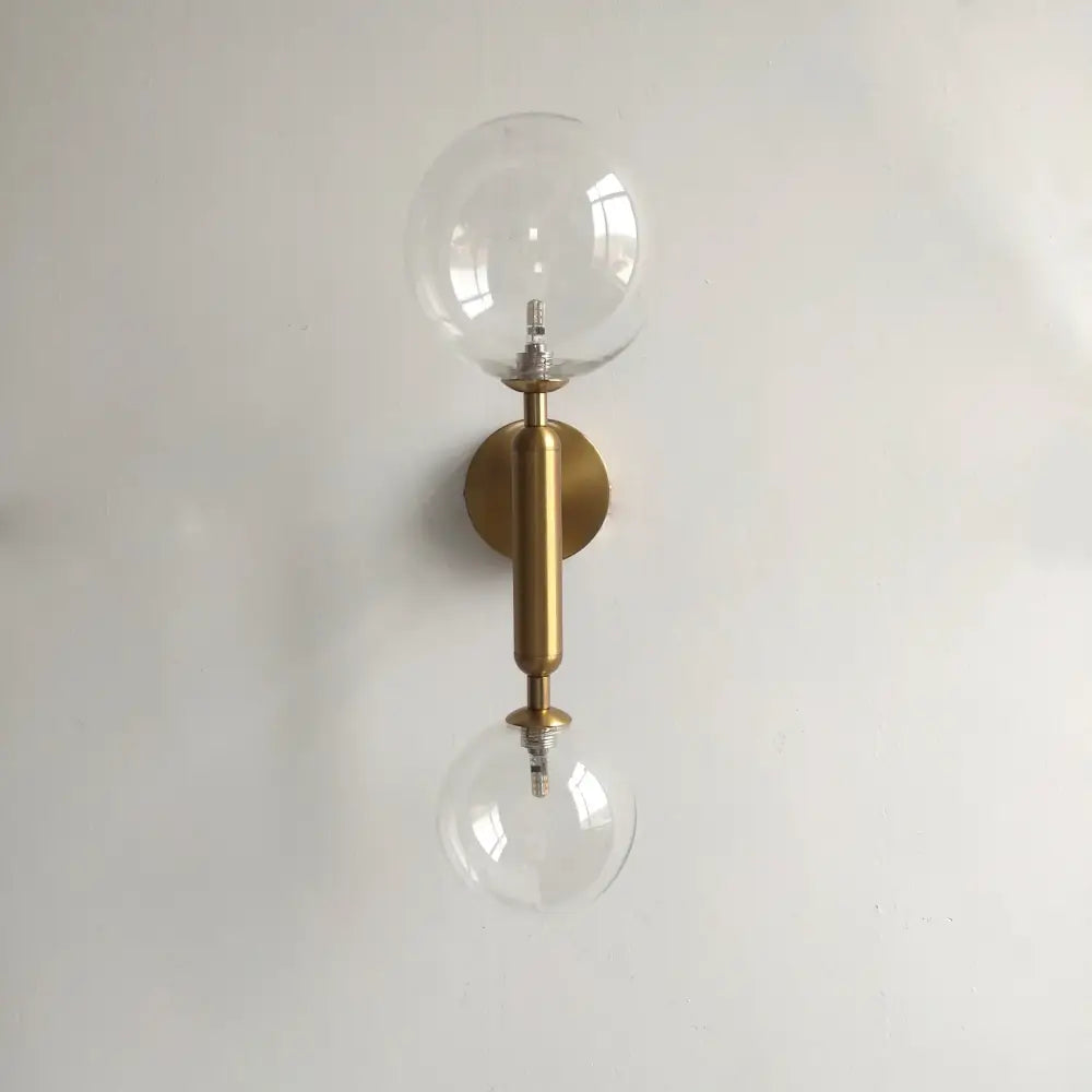 Modern golden led wall sconce with milky glass globes for bedroom