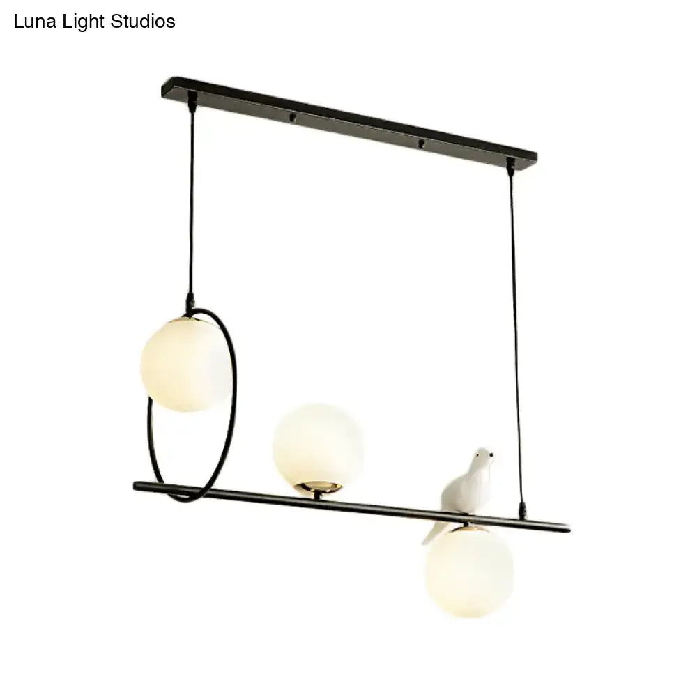 Modernist milk glass pendant with bird accent black dining room light