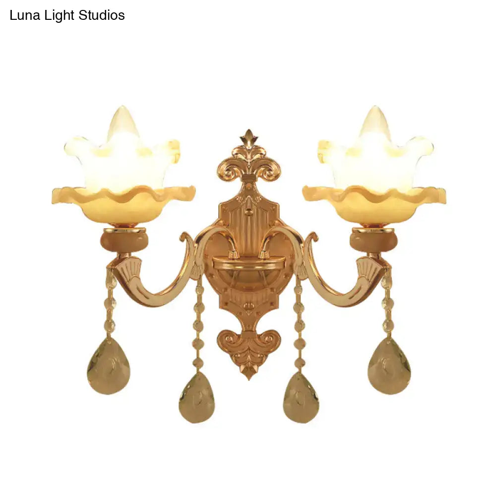 Ornate gold crystal wall sconce with frosted glass shade living room