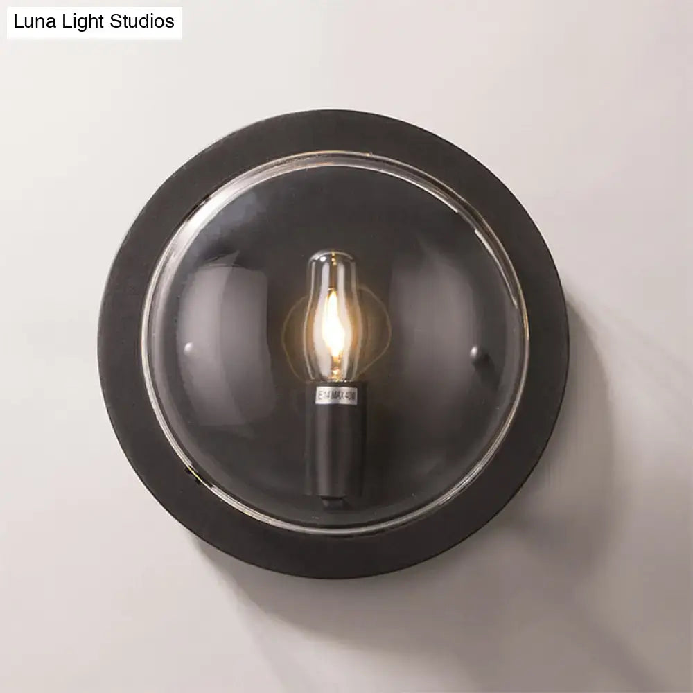 Retro dark gray metal wall sconce with clear glass shade living room