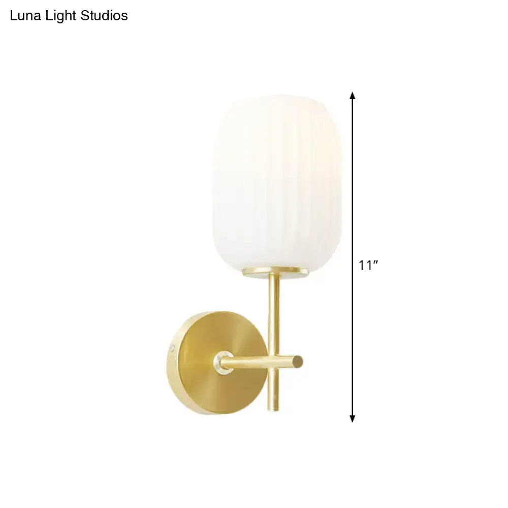 Simple gold light fixture with cream glass shade bedroom wall sconce