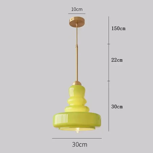Tiered yellow glass pendant lights with brass accents for kitchens