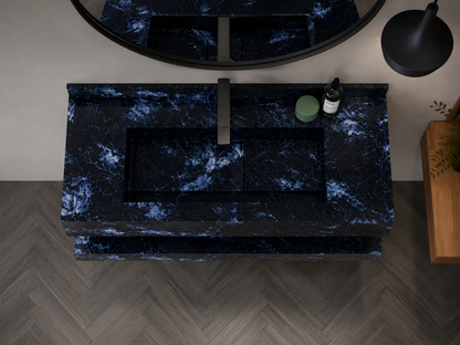 Marble bathroom vanity with black and blue veining, sink, and mirror.