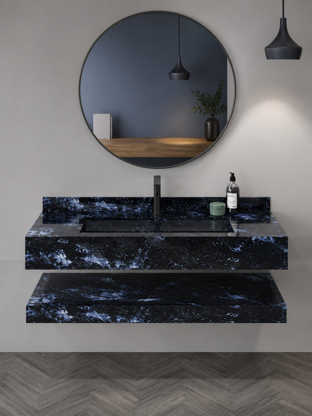 Modern bathroom vanity with black marble countertop, round mirror, and pendant lights.