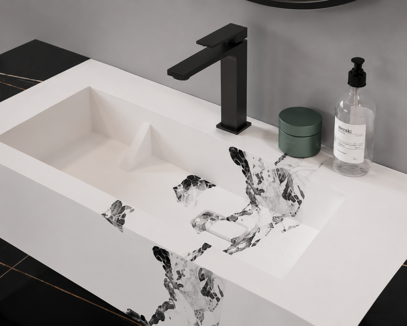 Bathroom sink with black faucet and decorative water feature