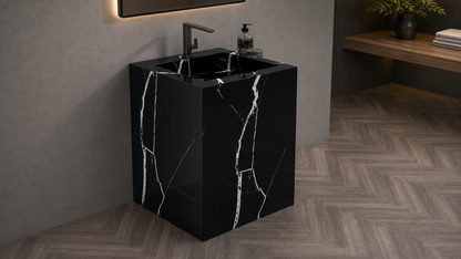 Black marble sink with faucet in a modern bathroom setting
