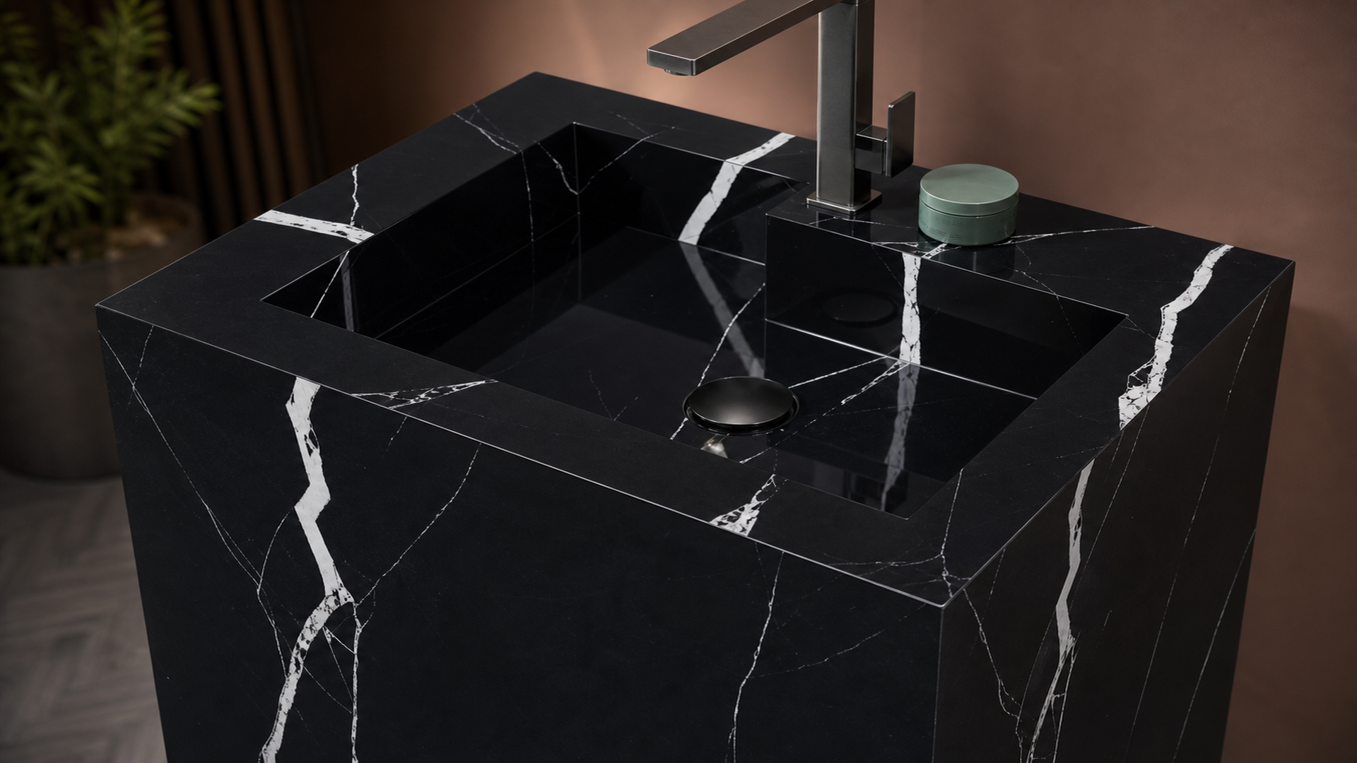 Black marble sink with faucet and soap on a blurred background