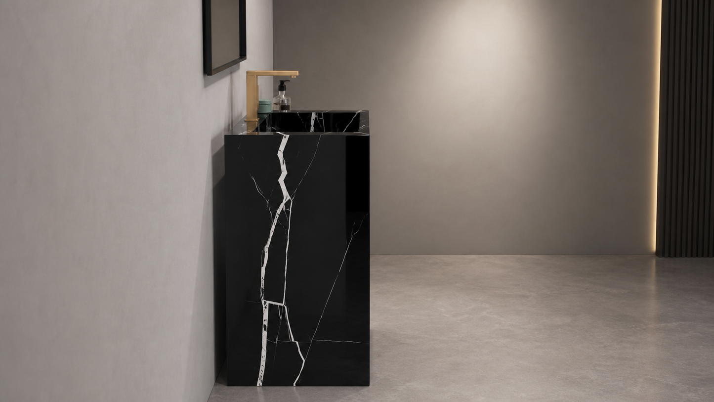 Black marble-patterned freestanding sink in a modern bathroom setting.