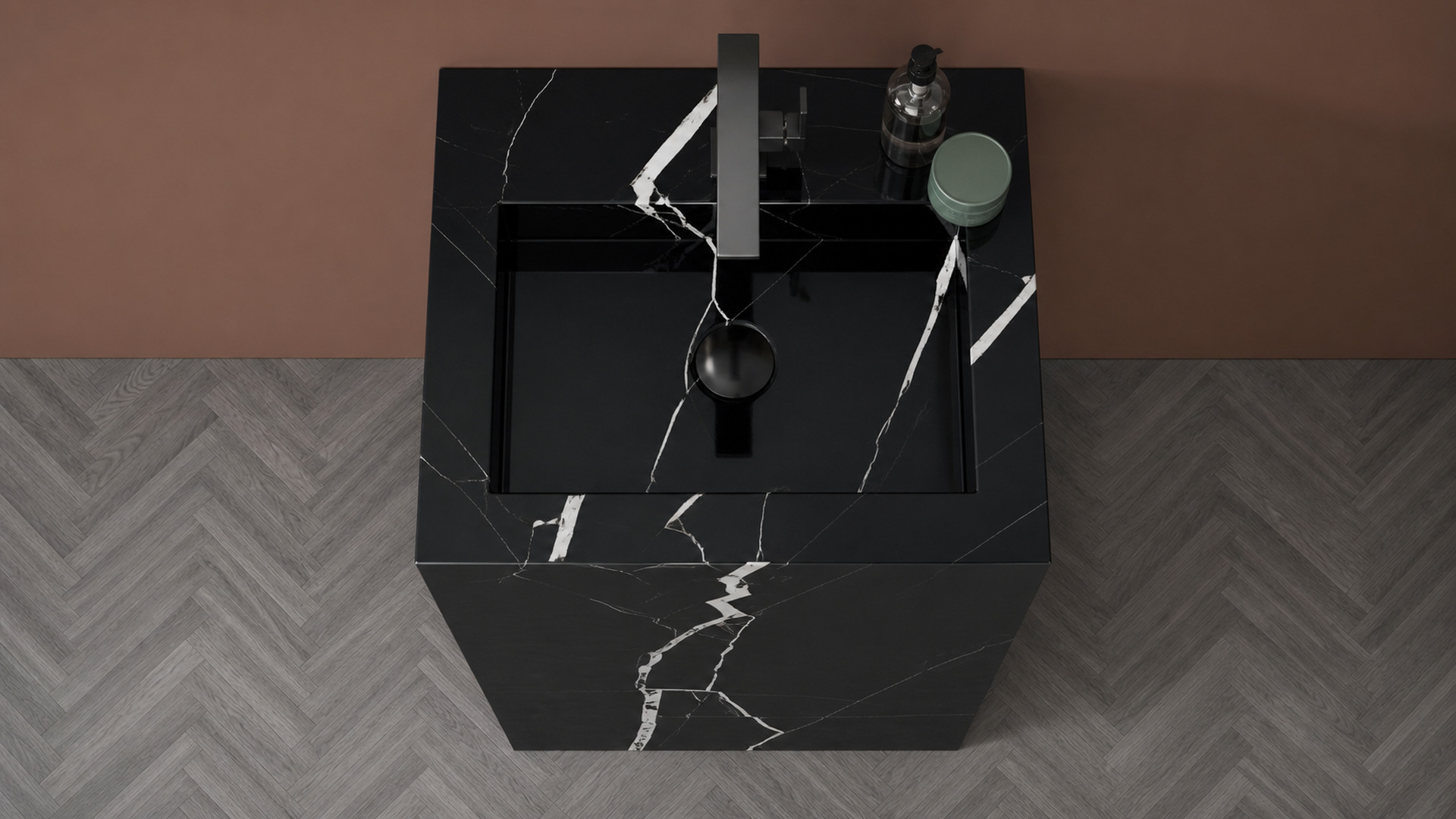Black marble sink with faucet on a gray and brown patterned floor