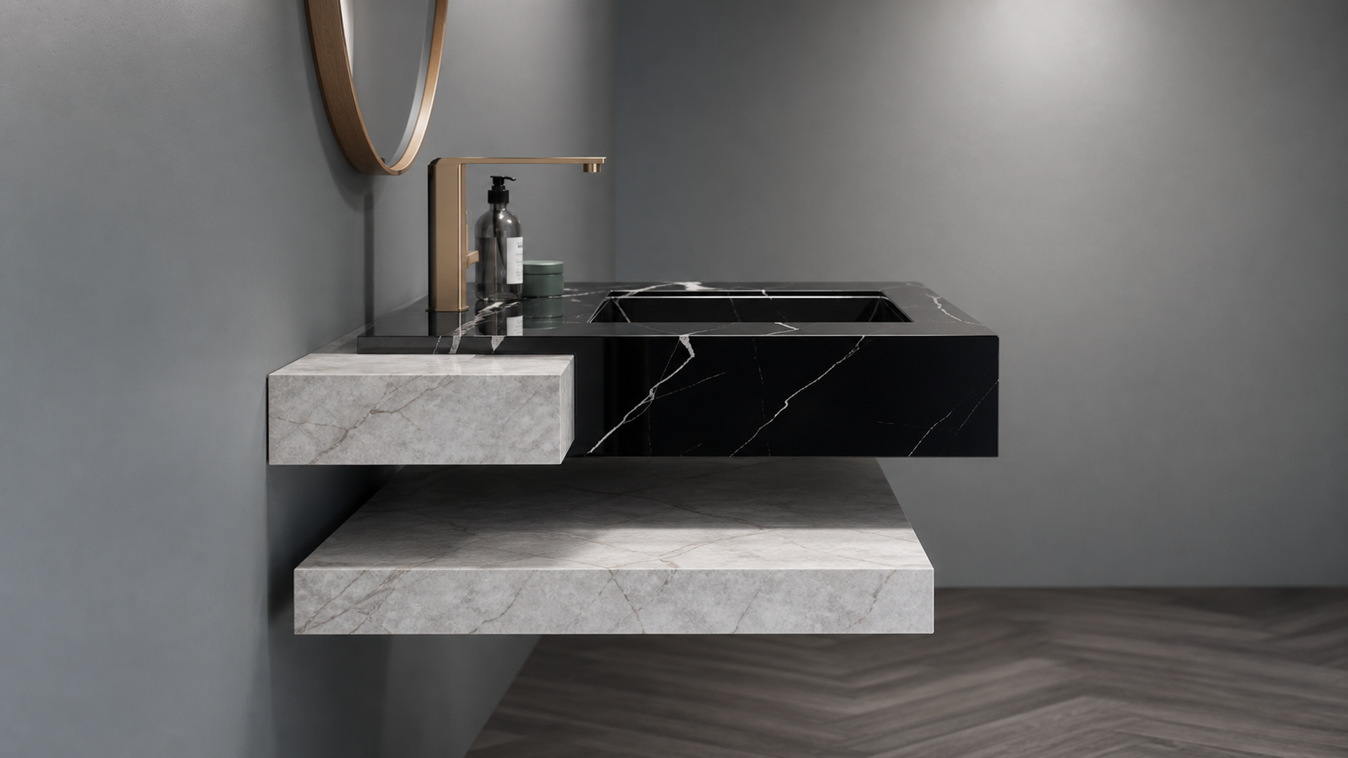 Bathroom vanity with black marble countertop and gray stone base against a gray wall.