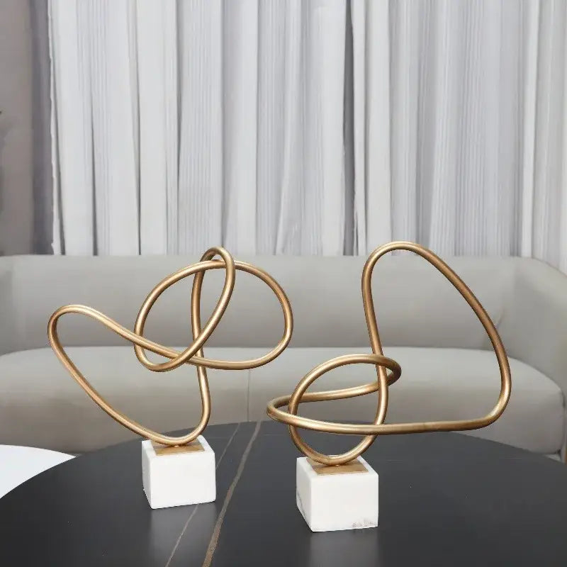 Abstract gold line geometric metal sculptures on marble living room decor
