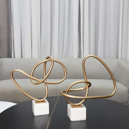 Abstract gold line geometric metal sculptures on marble living room decor