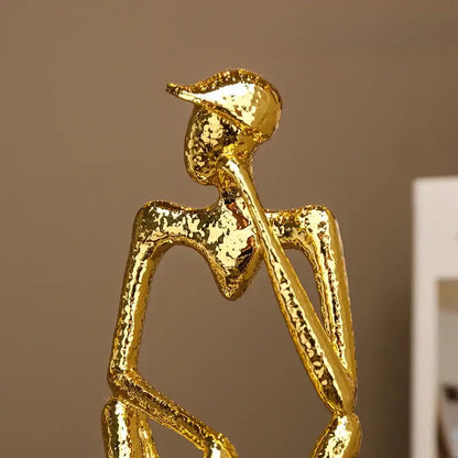 Abstract golden hat thinker figure living room gold & black decor