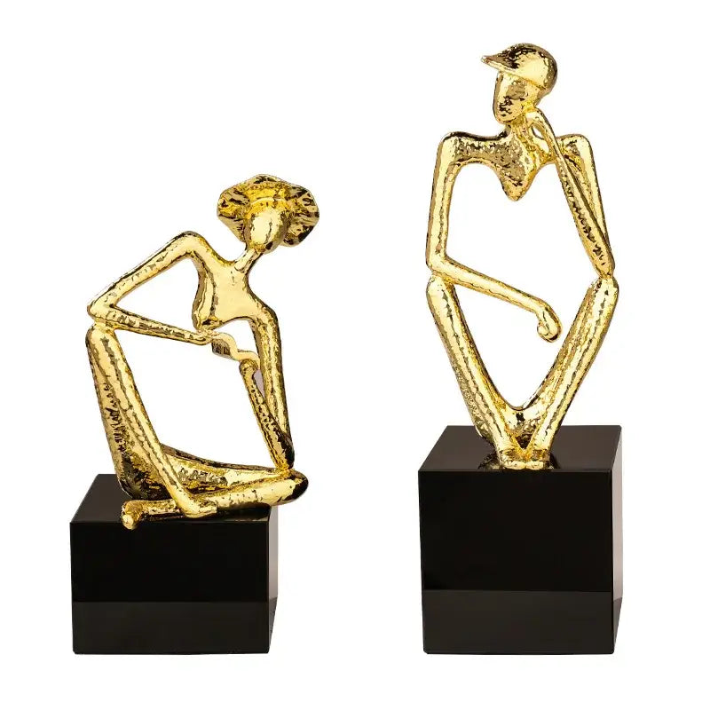 Abstract golden hat thinker figure living room gold & black decor