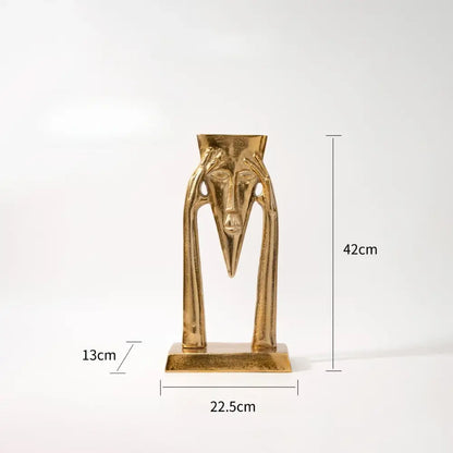 Abstract golden masked figure sculpture living room decor