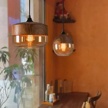 Amber glass and natural wood pendant light fixture for dining room
