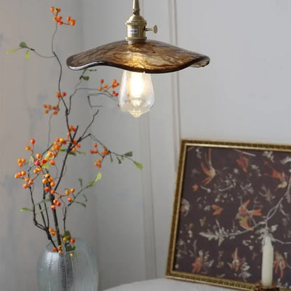 Amber glass pendant light with brass knob switch for dining room