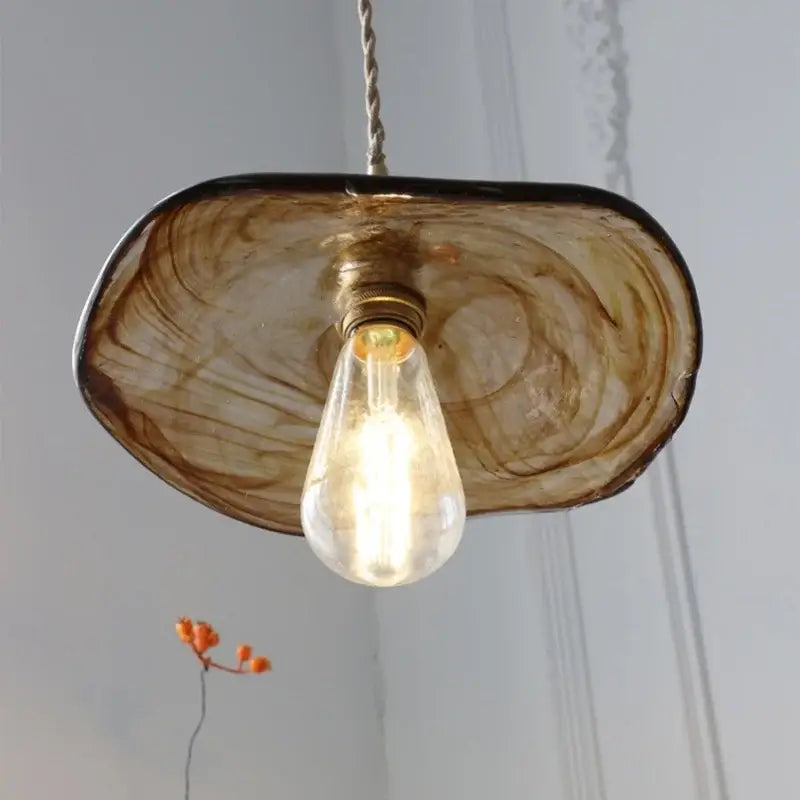 Amber glass pendant light with brass knob switch for dining room