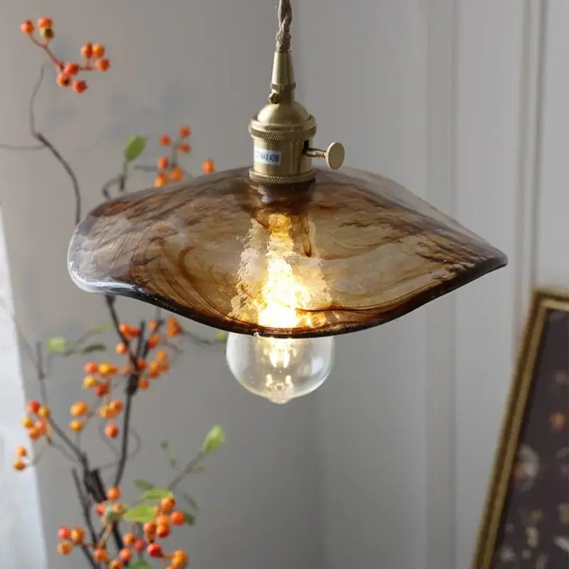 Amber glass pendant light with brass knob switch for dining room