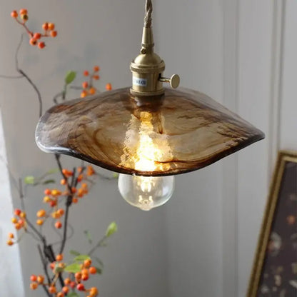 Amber glass pendant light with brass knob switch for dining room