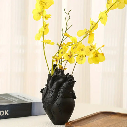 White anatomical heart vase with colorful flowers for living room