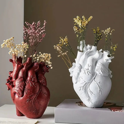 White anatomical heart vase with colorful flowers for living room