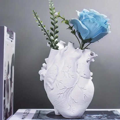 White anatomical heart vase with colorful flowers for living room