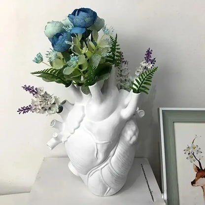 White anatomical heart vase with colorful flowers for living room
