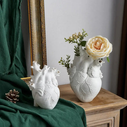 White anatomical heart vase with branches for living room decor