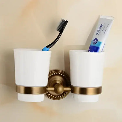 Antique brass bathroom set with ornate mounts and ceramic brush cup