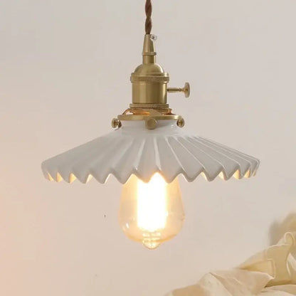 Antique brass ceramic walnut wall sconce with scalloped shade bedroom