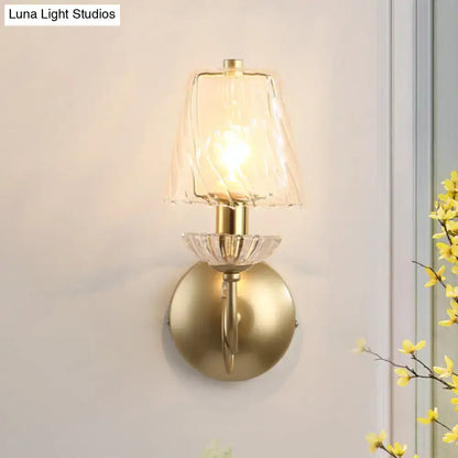 Antique brass conical sconce light with clear twisted glass bedroom