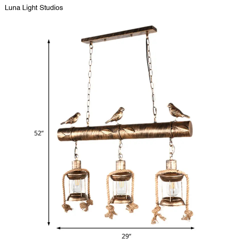 DecorBites™ Antique Brass Lantern Pendant with Clear Glass and Bird Accent - 3-Light Coastal Island Kit