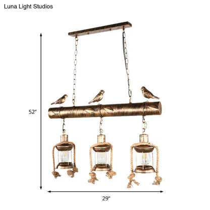 DecorBites™ Antique Brass Lantern Pendant with Clear Glass and Bird Accent - 3-Light Coastal Island Kit