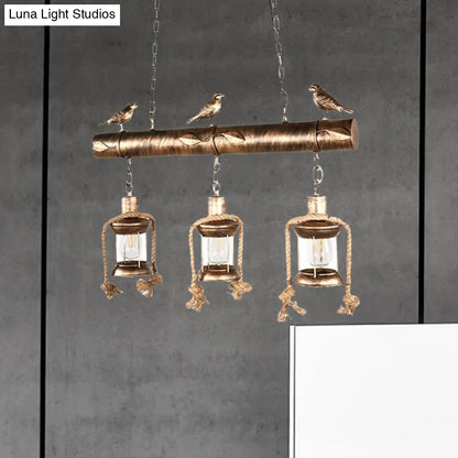 DecorBites™ Antique Brass Lantern Pendant with Clear Glass and Bird Accent - 3-Light Coastal Island Kit