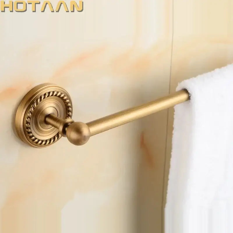 Antique brass single towel bar with ornate base for bathroom decor