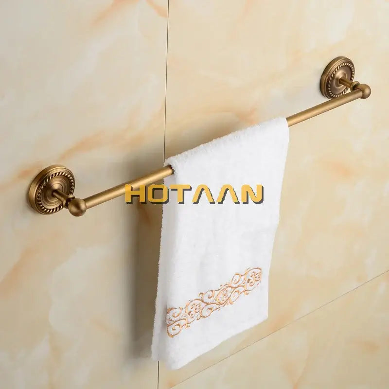 Antique brass single towel bar with ornate base for bathroom decor