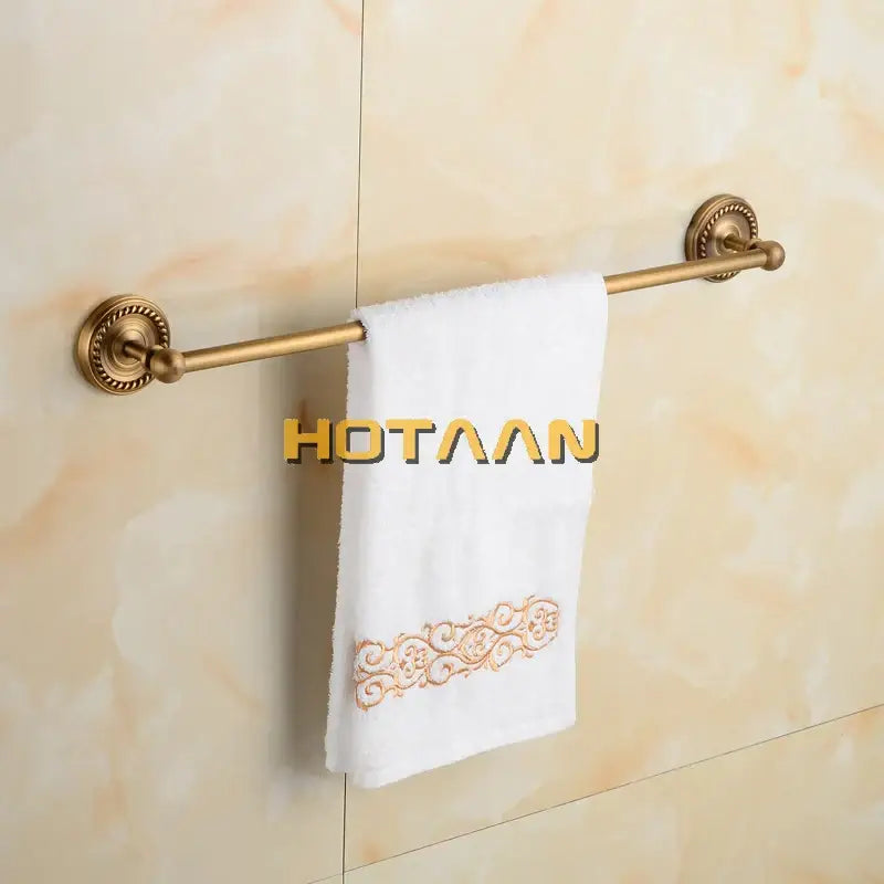 Antique brass single towel bar with ornate base for bathroom decor