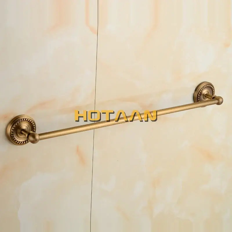 Antique brass single towel bar with ornate base for bathroom decor