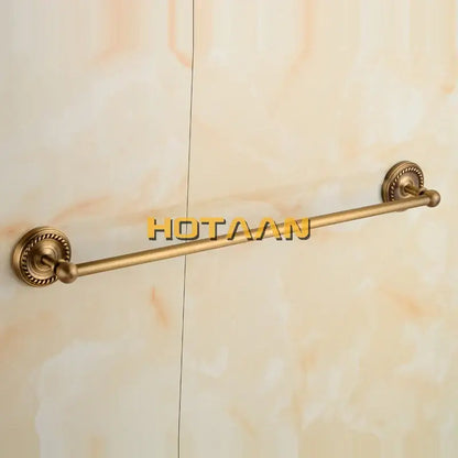 Antique brass single towel bar with ornate base for bathroom decor