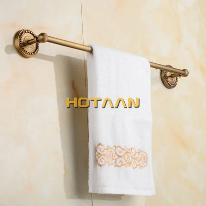 Antique brass single towel bar with ornate base for bathroom decor